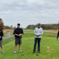 Four alumni together on golf course